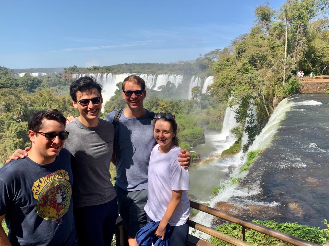 Four travelers in front of Iguazú Falls